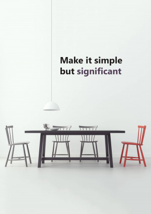 A minimalist dining room with a black table, chairs, and a single pendant light.