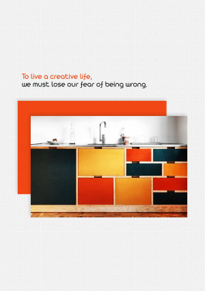 Modern kitchen with colorful cabinets and motivational quote
