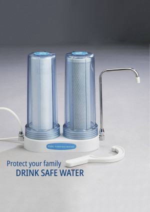 A white dual-stage water filter system with clear cartridges and a chrome faucet.