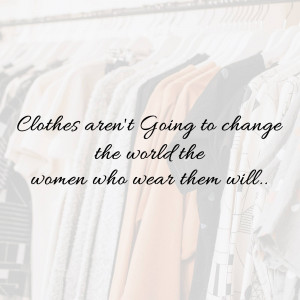 Clothes hanging in a closet with a motivational quote about women's empowerment.