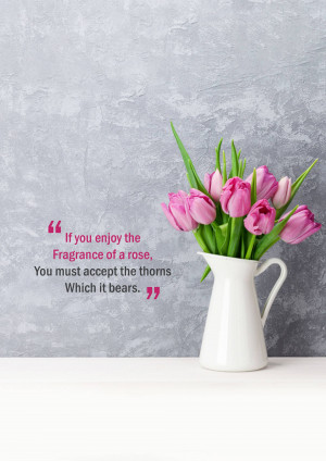 A bouquet of pink tulips in a white pitcher with a quote about roses and thorns.