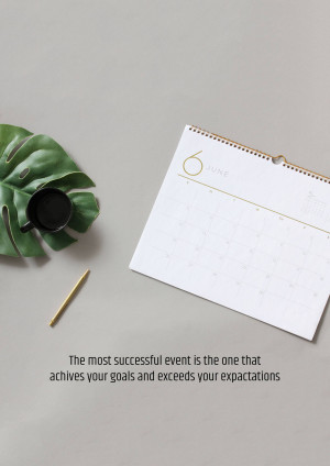 Flat lay of a June calendar page with a monstera leaf, coffee cup, and golden pen on a grey background.