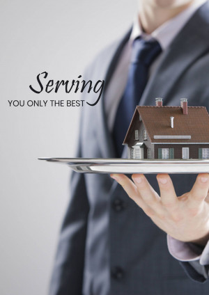 A person holding a miniature house on a silver platter.