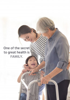 Three generations of women - grandmother, mother, and child - interacting with a walker.