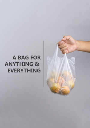 Hand holding a plastic bag with oranges inside against a gray background.