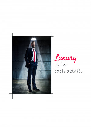 A man in a dark suit standing in a spotlight with the text 'Luxury is in each detail.'