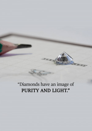 Close-up of a loose diamond on a sketch of a ring with a pencil