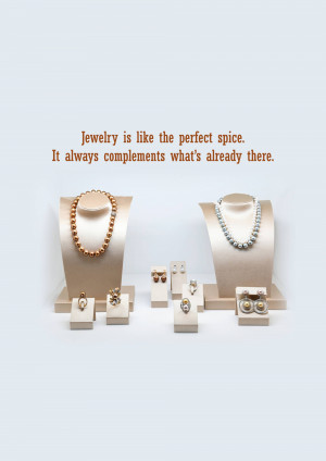 A display of various jewelry pieces including necklaces, rings, and earrings on beige stands.