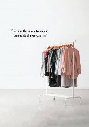 A white clothing rack filled with various garments against a white wall, with a fashion quote displayed above.