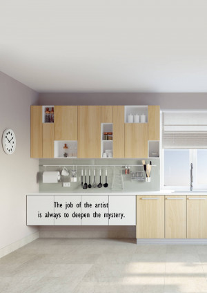 A bright and minimalist kitchen with light wood cabinets and a green backsplash.