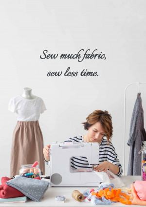 Woman sewing on a machine with fabric and clothing around her.