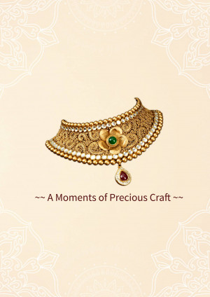 Close-up of a beautiful gold necklace with intricate detailing, an emerald flower pendant, and a ruby drop.