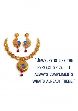 Close-up of a gold necklace and earring set featuring a peacock design.