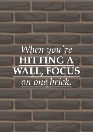 Motivational quote on a brick wall background