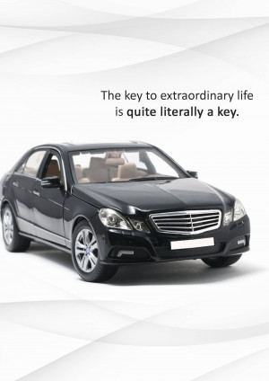 A silver and black model car with the text 'The key to extraordinary life is quite literally a key.'