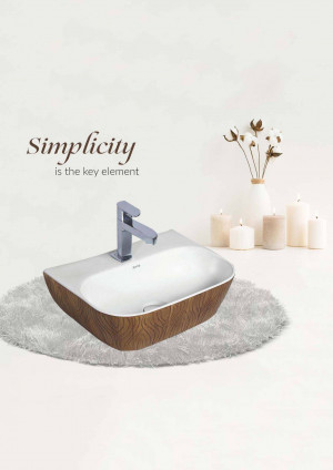 Close-up of a square white bathroom sink with a chrome faucet and candles in the background.