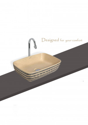 Close-up of a beige and black textured bathroom sink with a chrome faucet