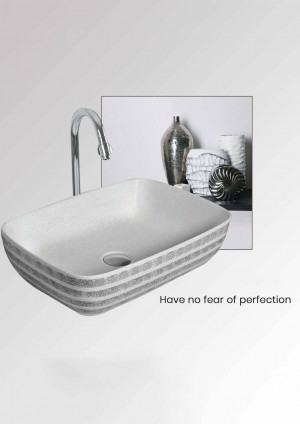 White rectangular bathroom sink with silver faucet and decorative accents