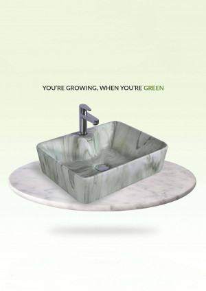 Modern green marble wash basin with black faucet on a white marble stand