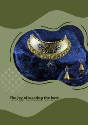 Close-up of a gold necklace with intricate floral design and matching earrings on a dark blue stone background.
