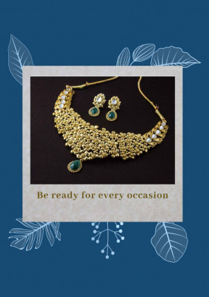Close-up of a gold necklace and earring set with emerald accents, displayed in a polaroid frame.