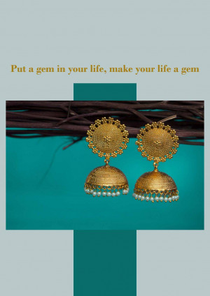 Close-up of ornate golden jhumka earrings against a teal background.