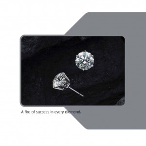 Close-up of a pair of silver diamond stud earrings on a dark textured background.