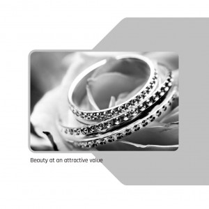 Close-up of diamond wedding rings on a white rose