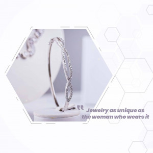 Close-up of a silver diamond bracelet on a white display stand