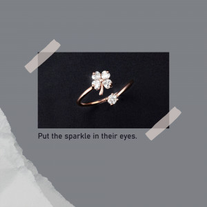 Close-up of a delicate rose gold ring with a four-leaf clover design and a single diamond.