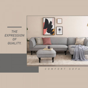 A stylish gray sectional sofa with decorative pillows and a matching ottoman in a minimalist living room setting.