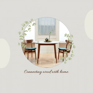Round wooden dining table with two chairs and botanical accents