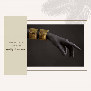 Close-up of a dark-skinned arm wearing two golden textured cuffs.