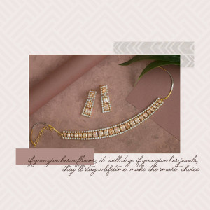 Close-up of a gold bracelet and earrings on a textured surface with a quote.