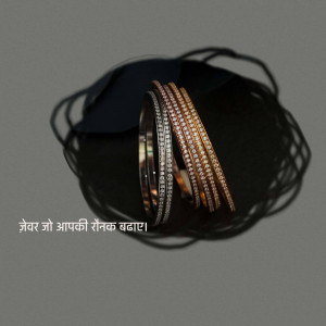 Close-up of stacked diamond bangles on a dark background