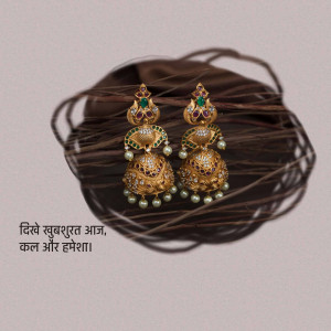 Close-up of ornate gold jhumka earrings with pearls and gemstones