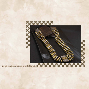 Close-up of a beautiful gold and silver beaded necklace on a black tray.