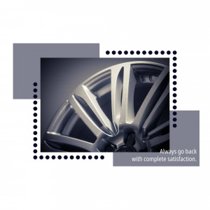 Close-up of a silver car wheel with a modern design