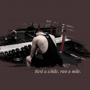 Athlete resting on a rowing machine in a gym