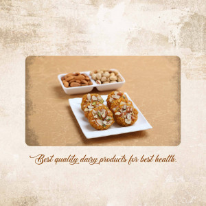 A close-up of a white platter with various Indian sweets like cashew nuts, almonds, and besan ladoos.
