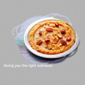 Close-up of sweet potato mash topped with pecans and peanuts on a silver plate.