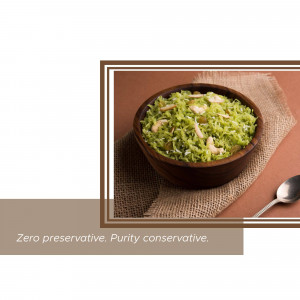 A close-up of a bowl of Sooji Halwa garnished with nuts.