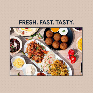 A vibrant overhead shot of a variety of Middle Eastern dishes including falafel, hummus, and grilled meats.