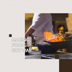 Chef flambéing food in a professional kitchen
