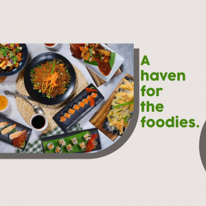 Overhead shot of various Asian dishes including sushi, noodles, and fried appetizers.