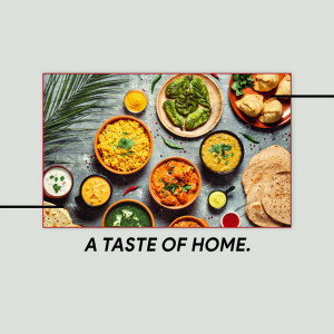 Overhead view of a variety of colorful Indian dishes including curry, rice, lentils, and bread.