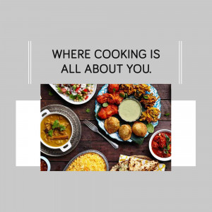 Overhead view of a variety of colorful Indian dishes arranged on a wooden table.