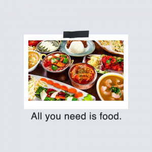 A variety of colorful Indian dishes served on a dark wooden table.
