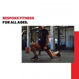 Woman performing a lunge exercise in a fitness gym.