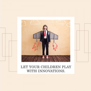 A young boy in a suit with cardboard wings and rocket boosters drawn on a wall.